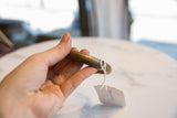 A hand-held view of the antique bronze bracelet highlighting its aged patina.