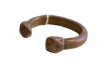Antique African snake cuff bracelet in copper alloy with hand-forged texture and etched ends.