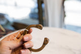 Antique copper snake cuff held in hand, showing its handcrafted form and aged patina.