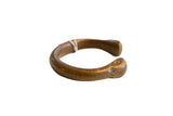 Antique African bronze snake cuff bracelet with a thick, curved form and time-softened patina.