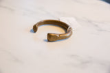 The open C-shape and time-softened patina of the antique African bronze snake cuff.
