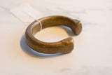 Thick, heavy form of the antique bronze snake cuff with etched end details.