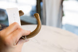Detailed view of handcrafted geometric carvings on the antique bronze snake cuff.