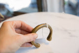 View of the antique bronze cuff showing its hand-forged shape and time-softened patina.