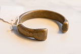 Profile of the antique bronze snake cuff bracelet showing its hand-forged, open shape.