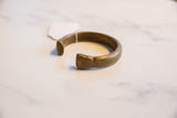 The open shape and substantial, aged patina of an antique African bronze cuff.
