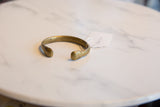 Side profile of the antique African bronze snake cuff, showing its open design and aged patina.