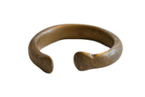 Antique African bronze snake cuff bracelet with a substantial C-shape and a dark, aged patina.