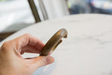 Profile of the antique bronze snake cuff showing its thick, curved form and time-softened patina.