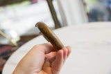 The smooth, worn texture and rounded end of the antique bronze cuff.