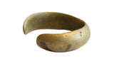 A wide antique African bronze cuff bracelet with a rich, time-worn golden patina.