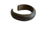 Antique African copper alloy bracelet with a thick, open-cuff shape and a rich, dark patina.