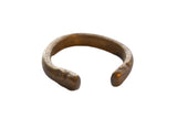 Antique African copper alloy snake cuff bracelet with a hand-forged shape and aged patina.