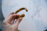 Sculpted snake head terminal of the antique African copper alloy bracelet.