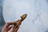 The aged copper alloy and handmade texture at the ends of an antique cuff.
