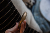 Side profile of the antique copper alloy cuff highlighting its smooth, time-softened patina.