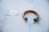 Close-up of the hand-stamped markings on the terminal of the antique snake cuff.
