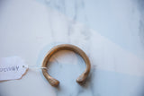 Overhead view of the antique copper alloy bracelet with its collector's inventory tag.