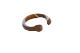 Antique African copper alloy snake cuff bracelet showing its aged, time-softened patina.
