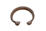 Antique African copper alloy snake cuff bracelet with an aged patina and etched line details.