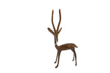 Vintage African bronze gazelle sculpture with a stylized form and tall, slender horns.