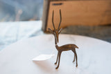 Tall horns and slender neck of the vintage African bronze gazelle sculpture.