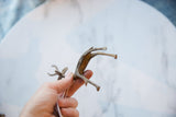 Underside view of the vintage African bronze gazelle showing its slender handmade form.
