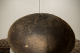 Aged wooden bowl rim with deep cracks and a corrugated metal repair.