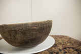 Aged dark wood texture of vintage African wooden bowl, showing natural character.