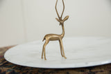 African bronze gazelle sculpture, slender front legs and textured hooves.