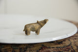 Collectible African bronze hippo figurine shown in profile with an upward gaze.