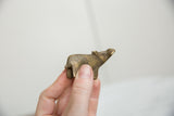 Vintage bronze hippo sculpture held to show its charmingly small, collectible size.