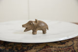 Side view of a vintage African bronze hippo with a rustic, handmade texture.
