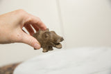 Vintage bronze hippo sculpture held to show handmade details and scale.