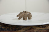 Profile view of a vintage bronze hippo sculpture highlighting its rustic, handmade texture.