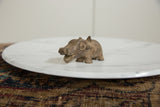 Three-quarter view of a vintage bronze hippo showing its aged surface.