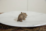 Rear view of a vintage bronze hippo highlights its handmade, textured surface.