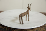 Vintage African bronze antelope sculpture, detailed carved body patterns and weathered patina.