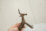 Vintage African bronze antelope held in hand, showing unique spiraled body texture.