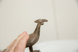 Aged patina and handmade texture on the head of the African bronze bustard bird.