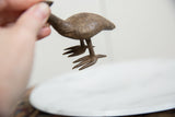 A detailed view of the handmade webbed feet of the bronze Kori bustard sculpture.