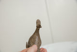 Rear view of the vintage African bronze bird's rustic, handmade texture.