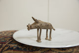 Side profile of a vintage African bronze warthog with visible handmade texture.
