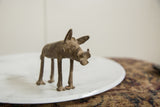 Angled view of a handmade bronze warthog showing textured details on its face.