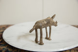 The handmade texture and aged patina on the back of the bronze warthog sculpture.