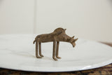 Profile view of a vintage African bronze warthog showing its handmade, rustic texture.