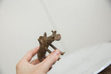Vintage African bronze warthog held in hand to show scale and form.
