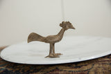 Handmade African bronze bird sculpture in profile showing etched body details.