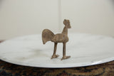 Rear view of the vintage bronze bird highlights its wide tail and textured body.