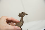 Handmade texture and aged patina on the head of a vintage African bronze bird.